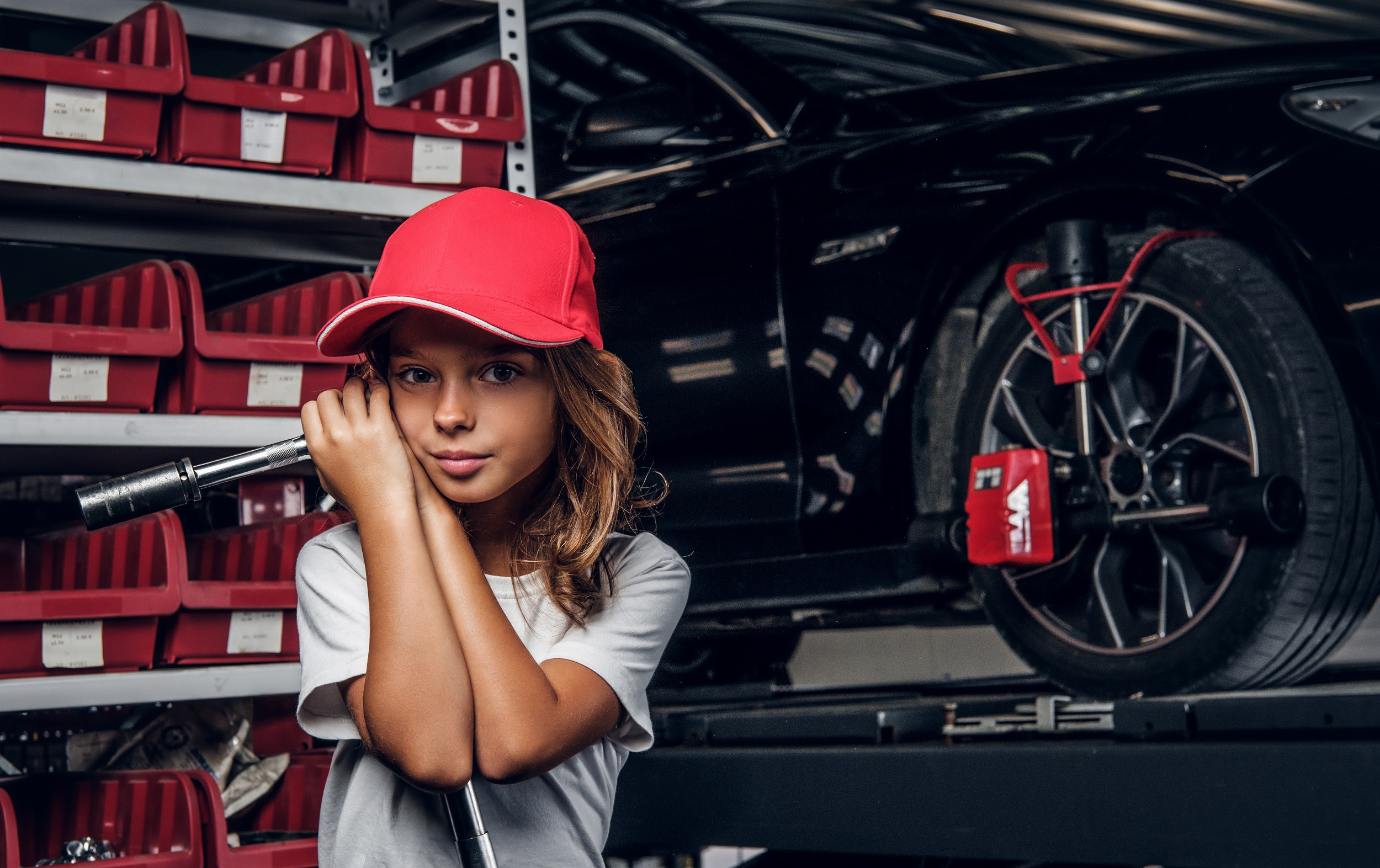 Portrait of cute kid at auto service workshop